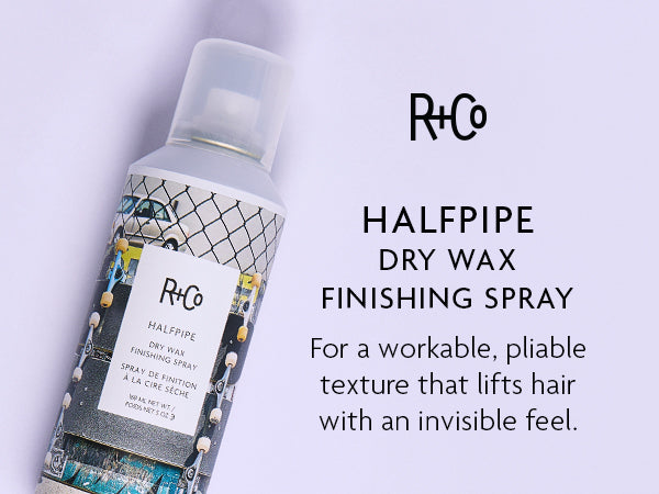 R+Co Halfpipe Dry Wax Finishing Spray bottle on a light purple background