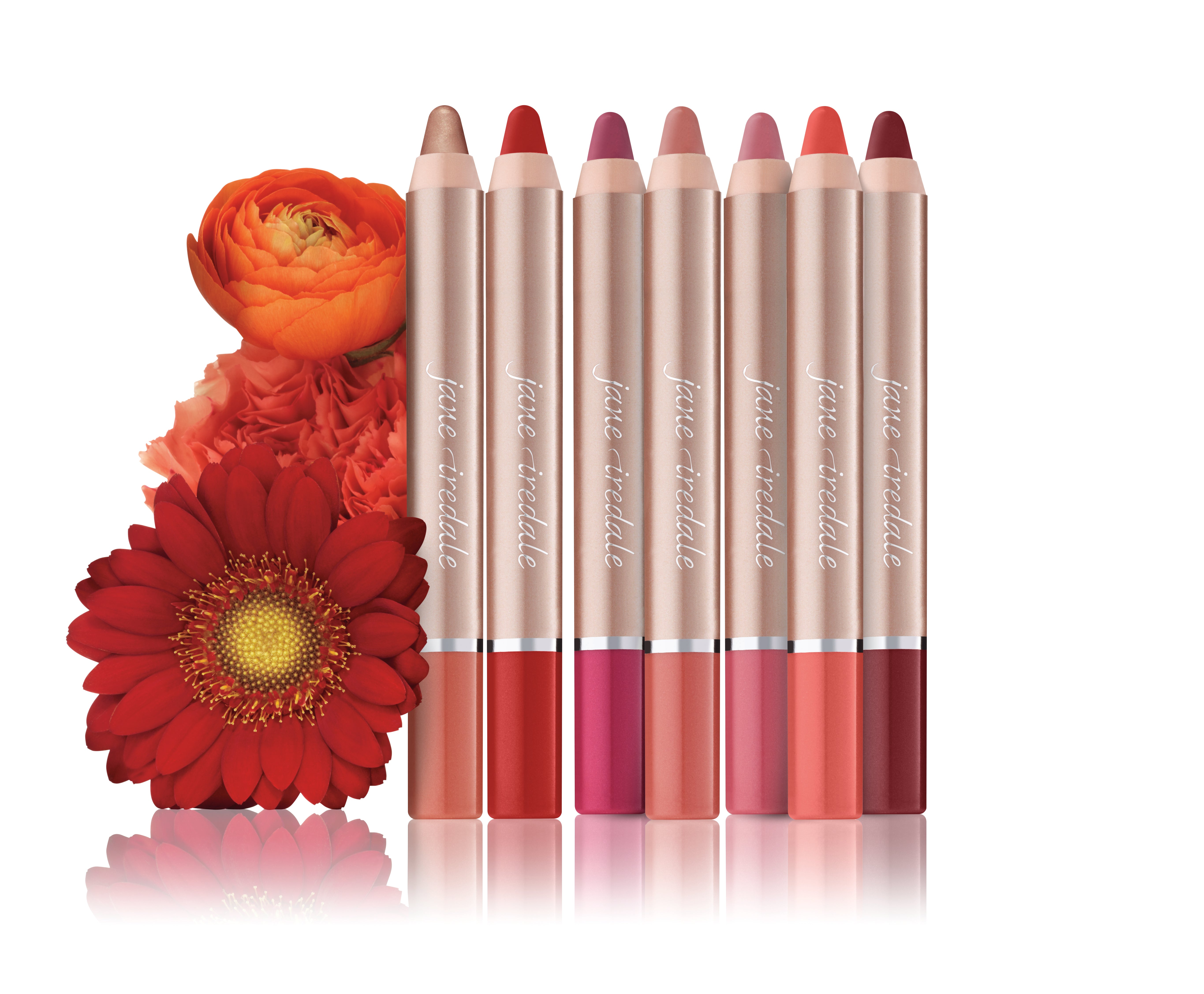 Set of lip pencils with red and pink shades and flowers on a white background