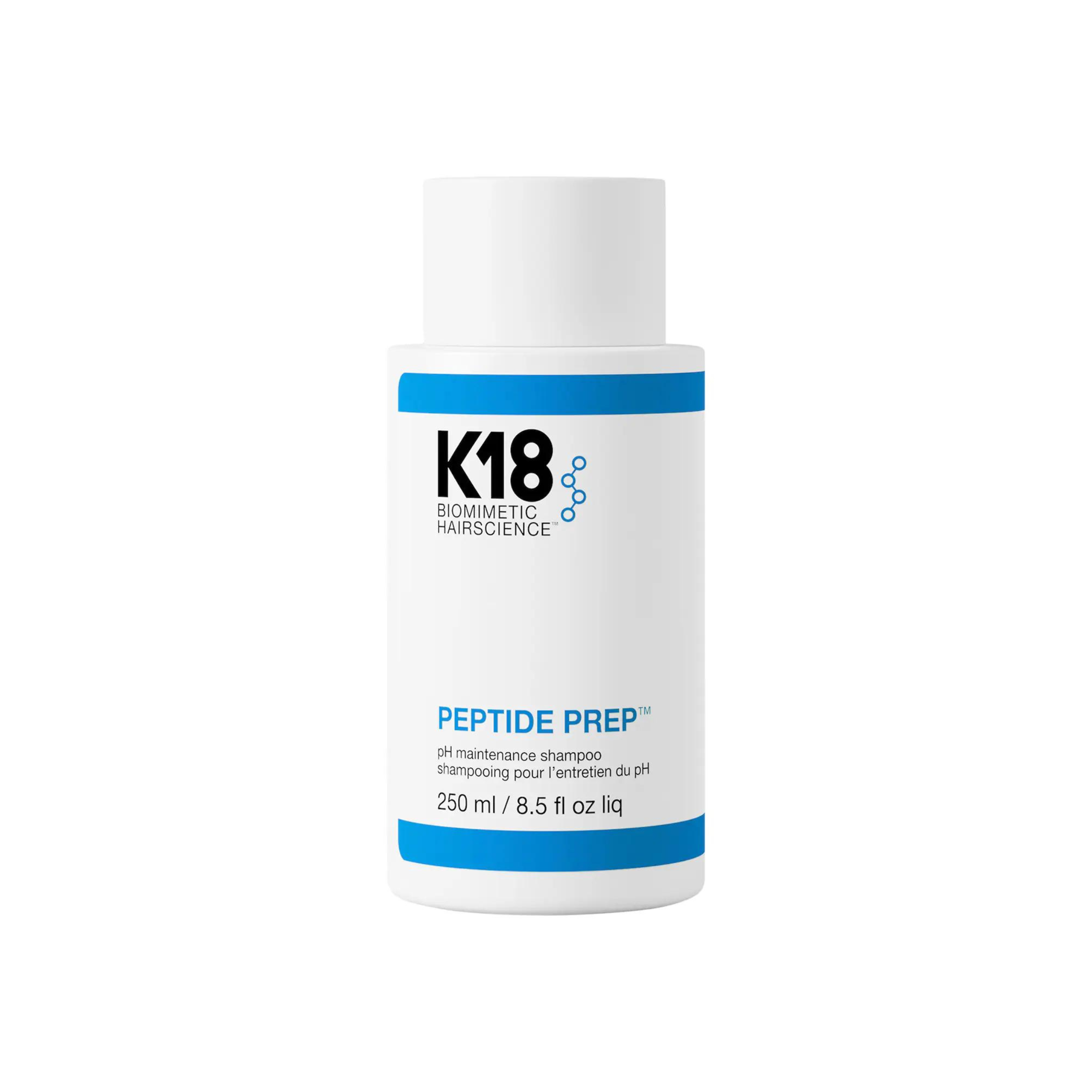 A bottle of K18 Peptide Prep pH Maintenance Shampoo with a white and blue label.