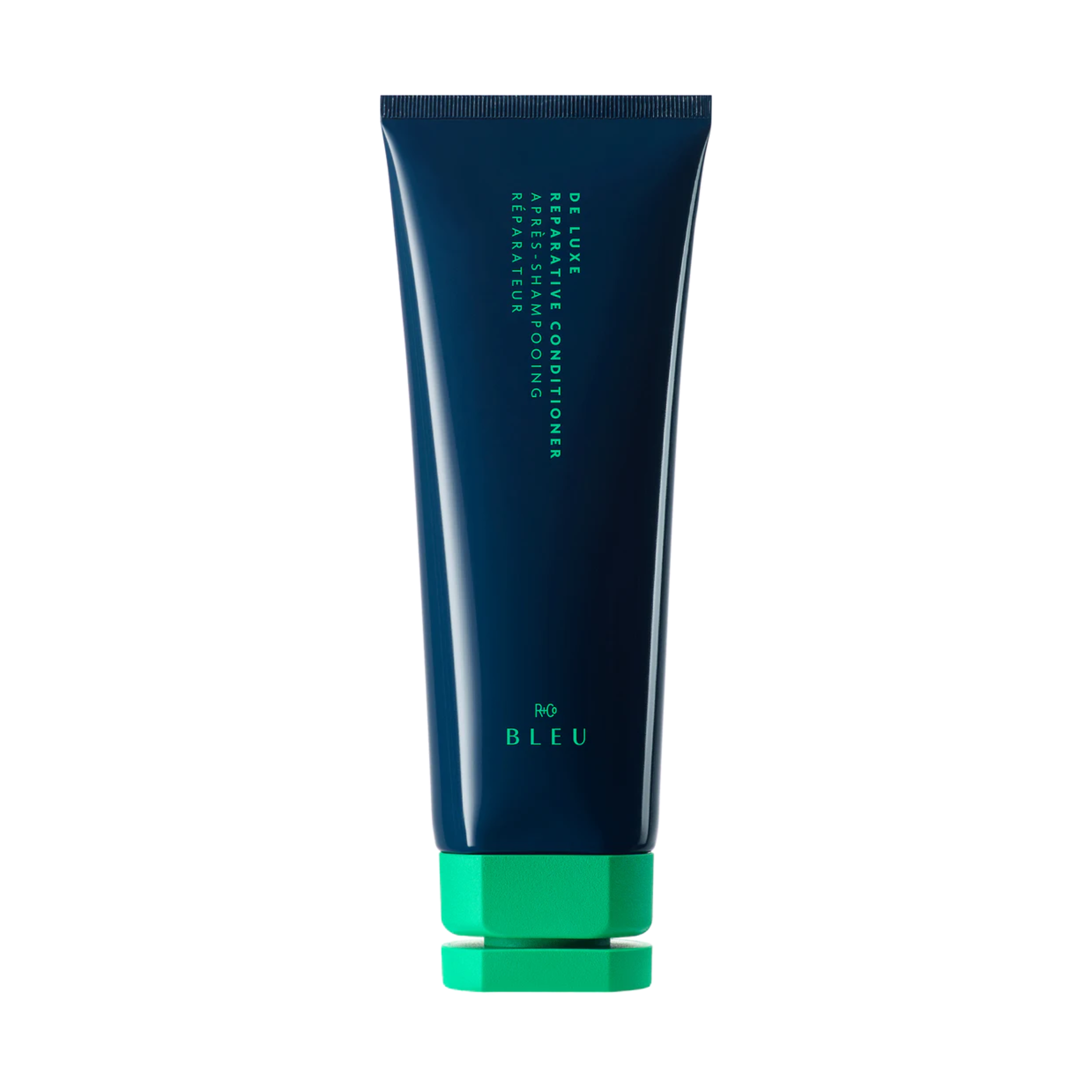 A blue tube of R+Co BLEU De Luxe Reparative Conditioner with a green cap.