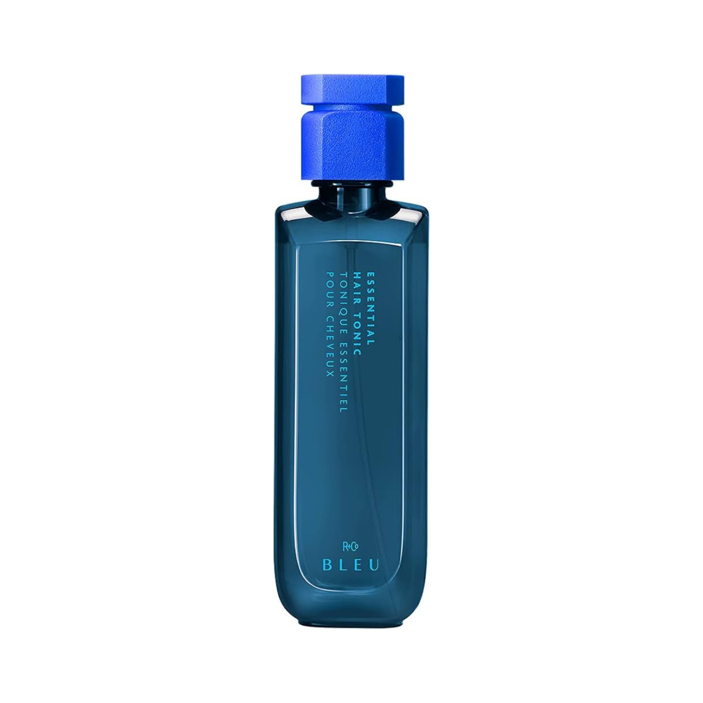 A bottle of R+Co BLEU Essential Hair Tonic with a blue cap and label, standing upright against a white background.