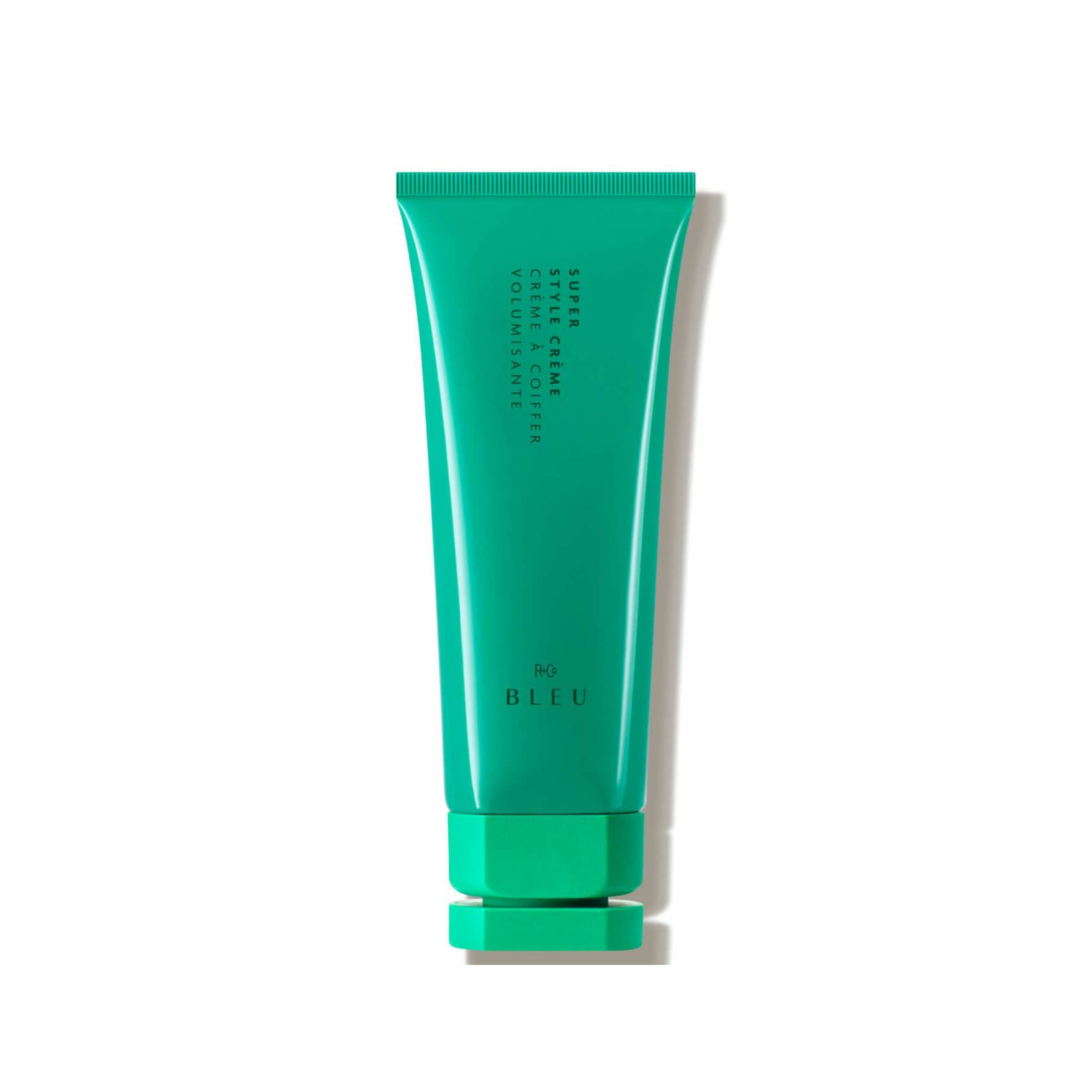 A green tube of R+Co Bleu Super Style Creme, a hairstyling product.