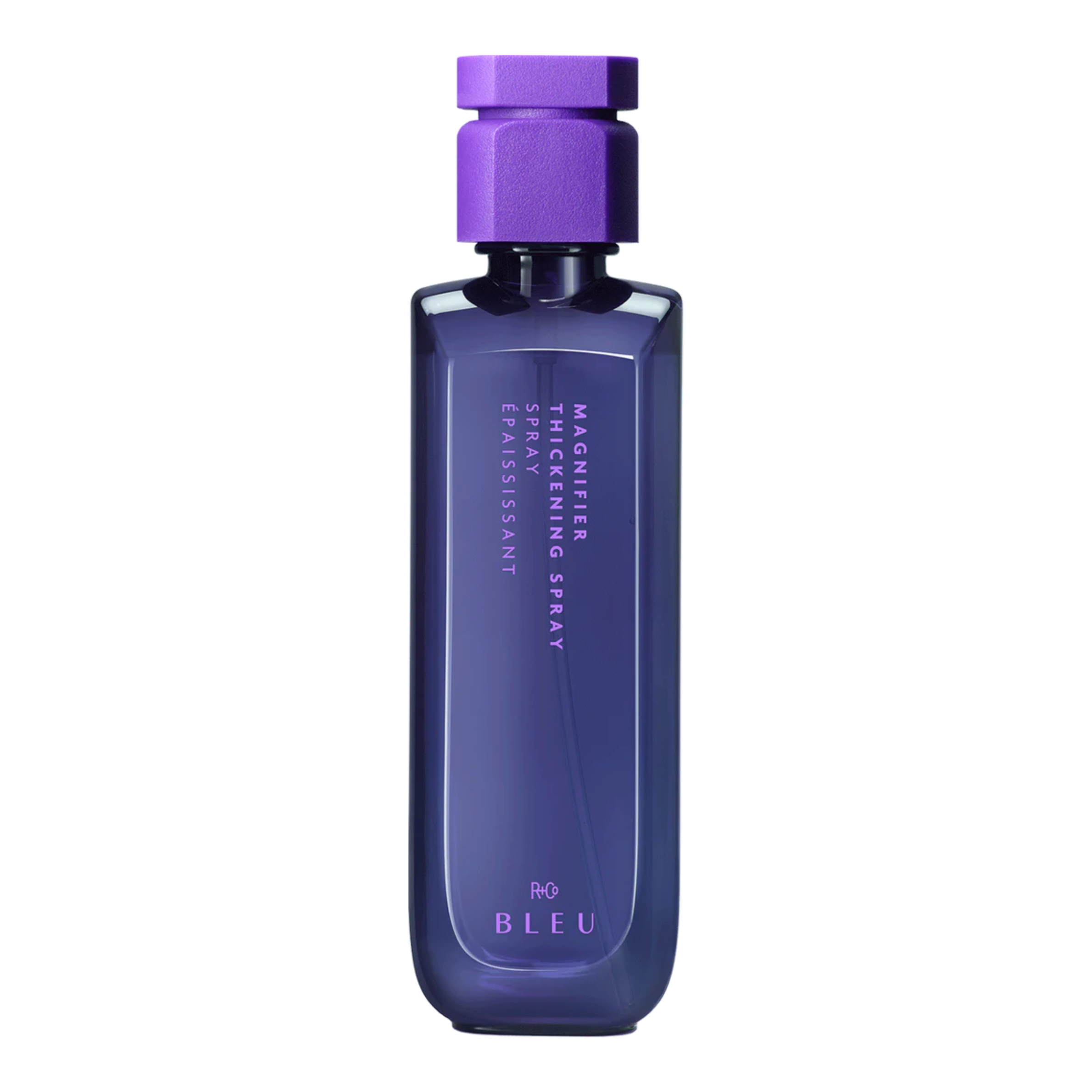 A purple bottle of R+Co BLEU Magnifier Thickening Spray with a sleek design.