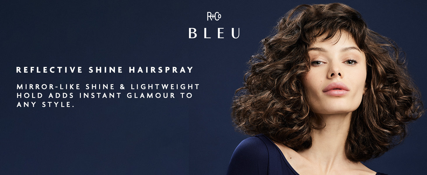 Advertisement for R+Co Bleu reflective shine hairspray with a woman with styled hair against a dark blue background.