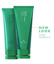 Two green skincare products with text indicating a new look and same formula on a white background.