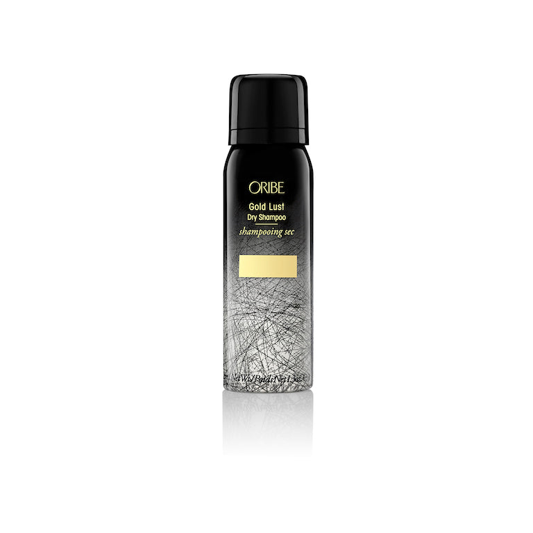 A bottle of Oribe Gold Lust Dry Shampoo with a black and white design