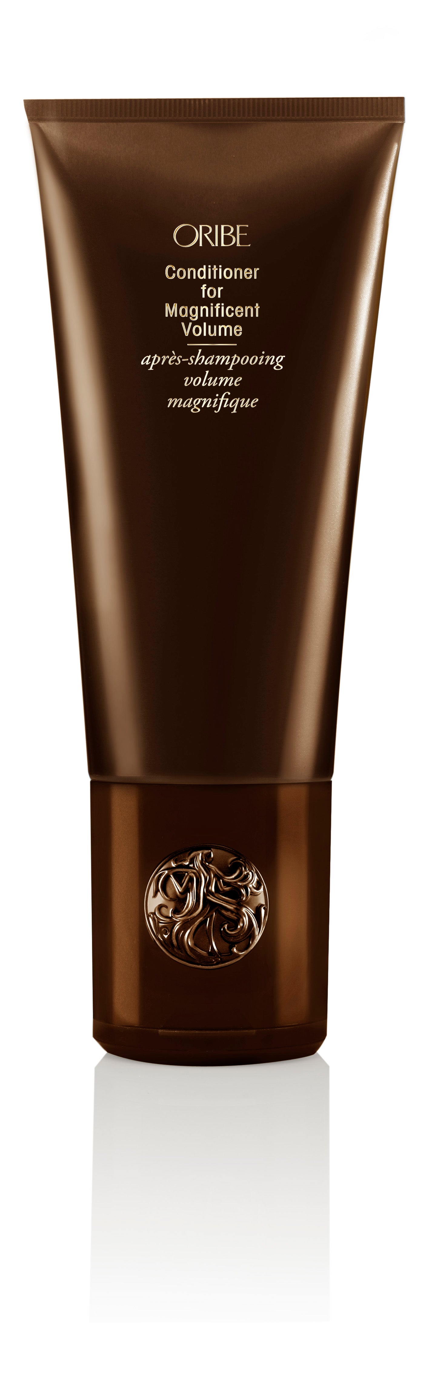 A tube of Oribe conditioner with a brown exterior and the brand's logo visible on the packaging.