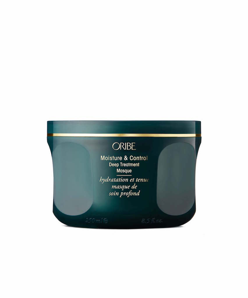 A green jar of Oribe Moisture & Control Deep Treatment Masque with hydrolyzed baobab seed extract, showing the product's branding and the product name.