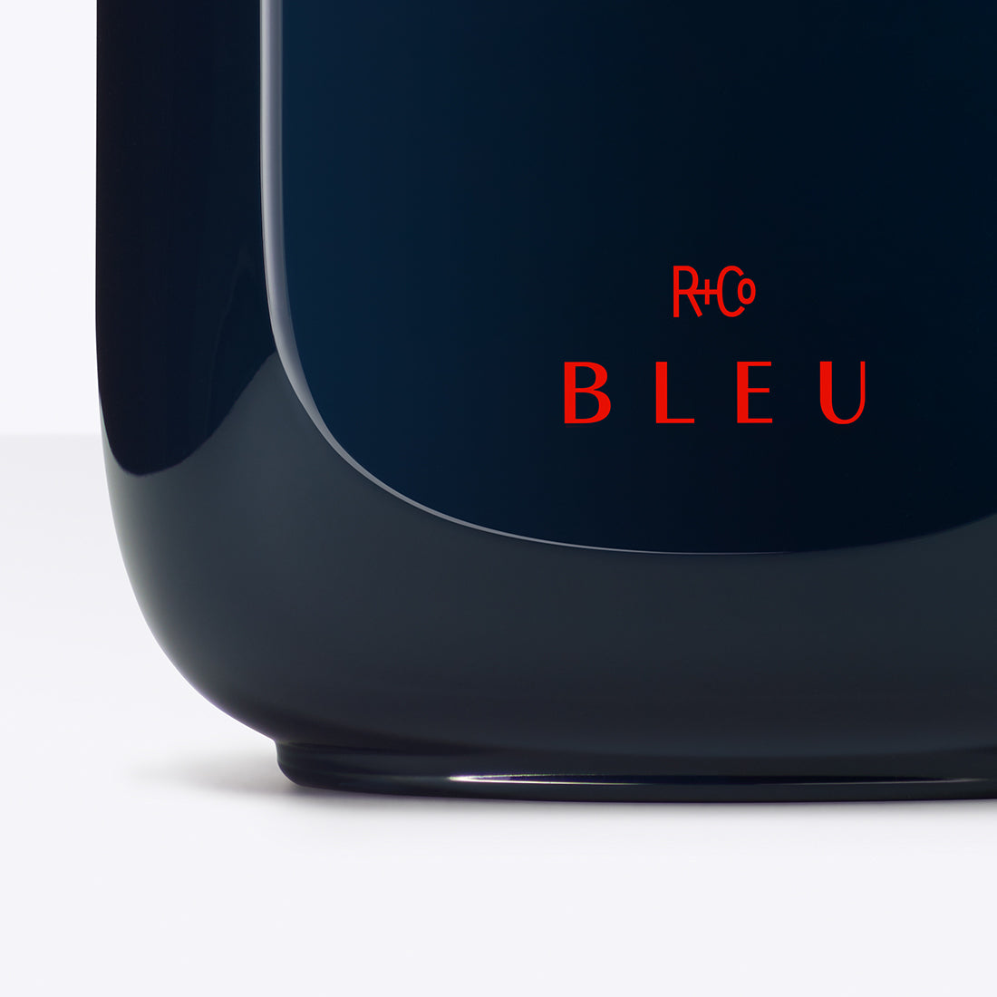 R+Co BLEU logo on blue bottle and white background