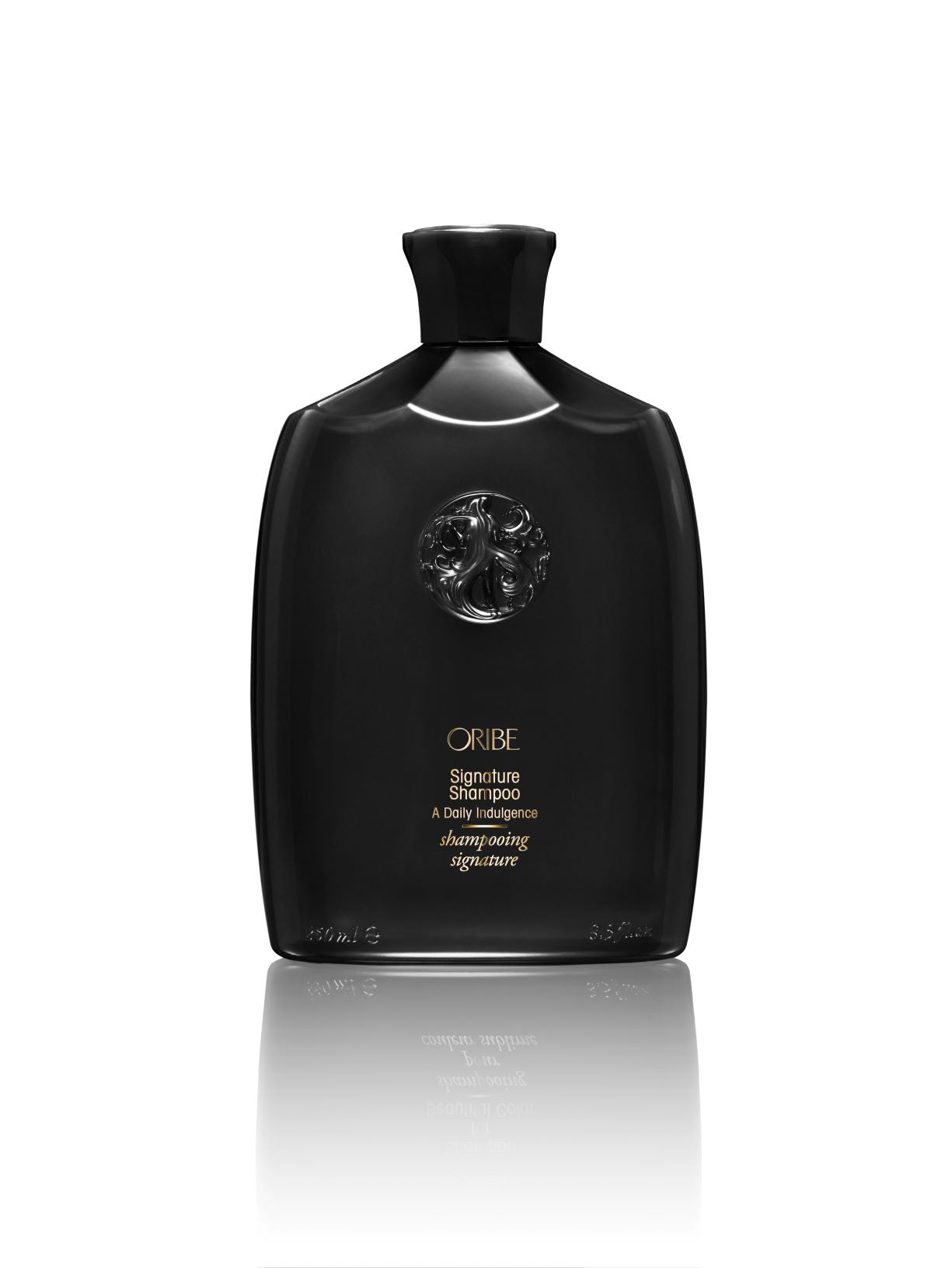 Bottle of Oribe shampoo on white background