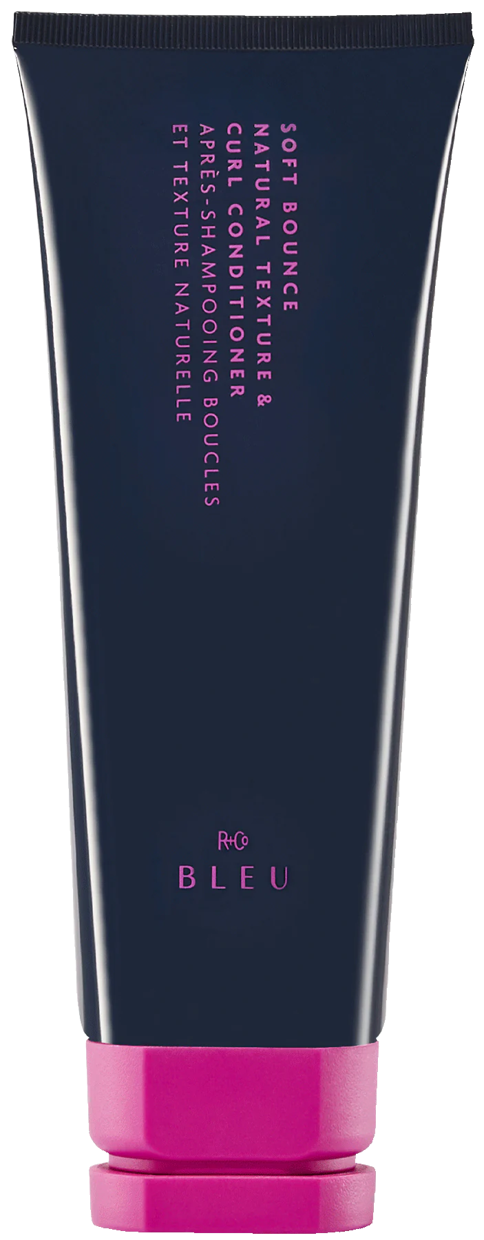 A tube of R+Co BLUE Soft Bounce Natural Texture & Curl Conditioner with a navy body and pink cap.