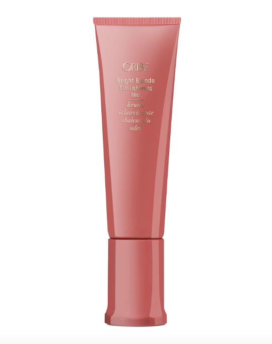 A pink spray bottle of Oribe Bright Blonde Sun Lightening Mist, designed to lighten and enhance blonde hair.